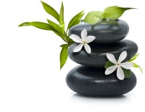 Stones stacked with white flowers