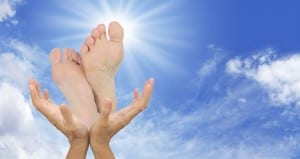 Hands holding up feet into the sky